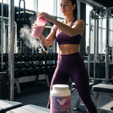 Athletic woman drinking Royal Protein whey protein shake in a lifestyle fitness setting