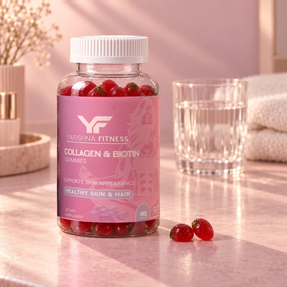 Yarishna Fitness Collagen & Biotin Gummies bottle on a vanity with two gummies and a glass of water